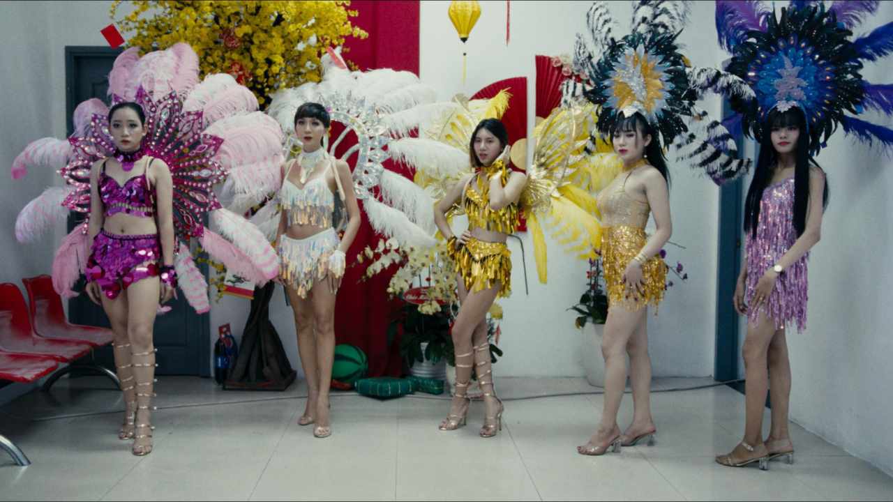 a group of young women in extravagant feathers